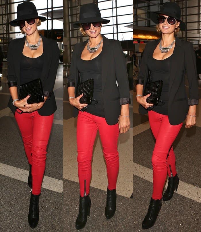 Paris Hilton rocks red leather pants with a chic black blazer and stylish accessories at LAX
