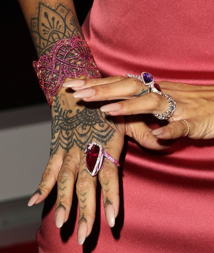 Rihanna added matching rings and an intricate ruby cuff around her tattooed wrist