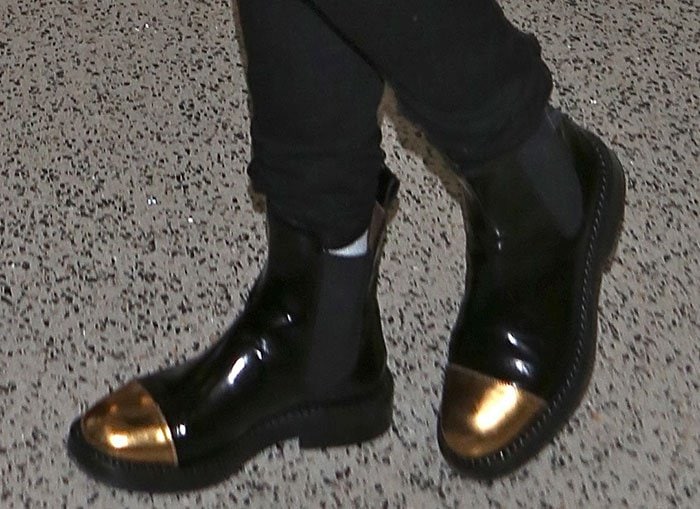 Rita Ora's boots feature shining metallic gold toe caps