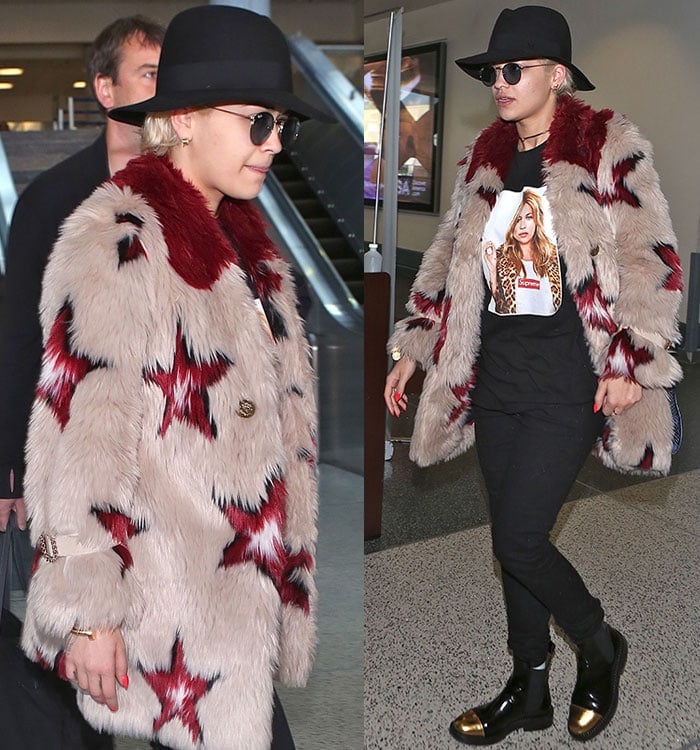 Rita Ora rocks a two-tone fur coat that features star prints