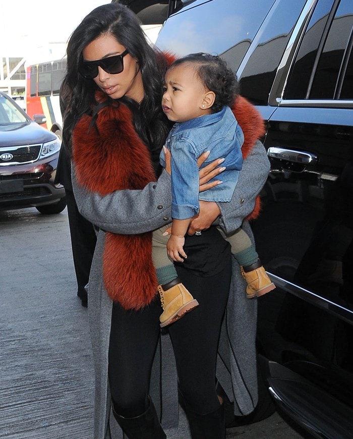 Kim Kardashian and North West (in Timberland toddler boots) at LAX on September 22, 2014