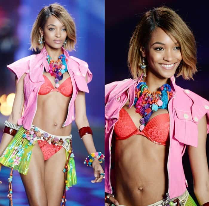 Jourdan Dunn showcases a vibrant outfit featuring a coral lingerie set paired with a pink vest and colorful statement accessories