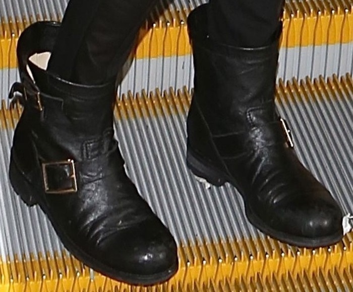Emmy Rossum's edgy Jimmy Choo biker boots add a bold touch to her chic airport look