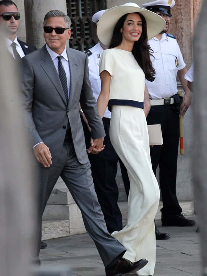 Amal Alamuddin exudes timeless elegance in a white Stella McCartney ensemble and wide-brimmed hat during her civil union with George Clooney in Venice, Italy, on September 29, 2014