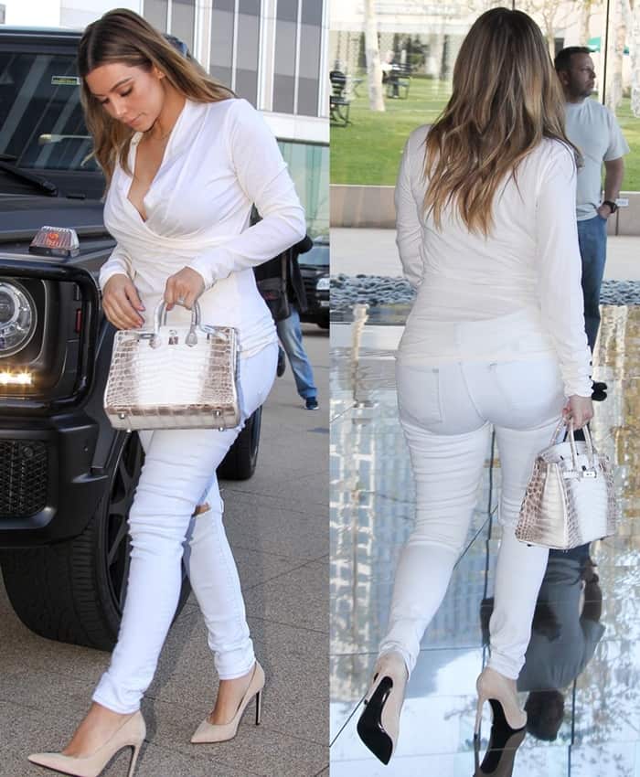 Kim Kardashian stuns in an all-white ensemble with nude pumps and a rare white crocodile Hermès Birkin while arriving at an office in Century City, California, on January 10, 2014