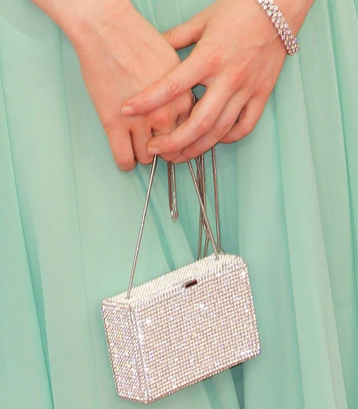 Andrea Riseborough shows off her glittering Swarovski clutch