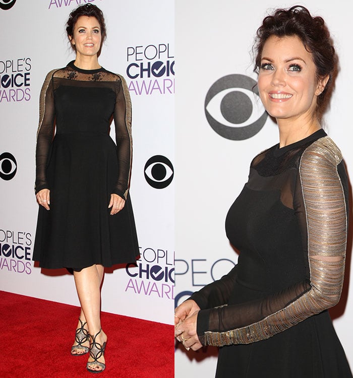 Bellamy Young in a black Alberta Ferretti dress featuring a lace insert at the neck and sheer long sleeves embellished with metallic gold and silver chains