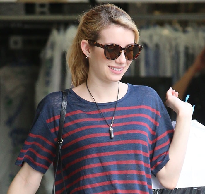 Emma Roberts wears TOMS sunglasses while picking up her dry-cleaned clothes