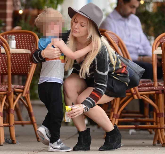 Hilary Duff styled a Raquel Allegra V-neck cashmere pullover with a Proenza Schouler python and leather bucket bag and Belle by Sigerson Morrison Kyeran black suede ankle boots in Los Angeles on January 28, 2015