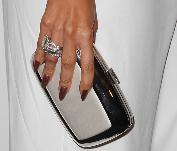 Jennifer Lopez's glittering rings and a metallic clutch