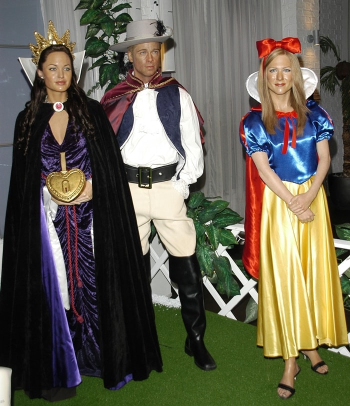 Popular tourist attraction Madame Tussauds unveils its seasonal waxwork scene, featuring models of (L-R) Angelina Jolie as the Wicked Stepmother, Brad Pit as Prince Charming from Snow White, and Jennifer Aniston as Snow White