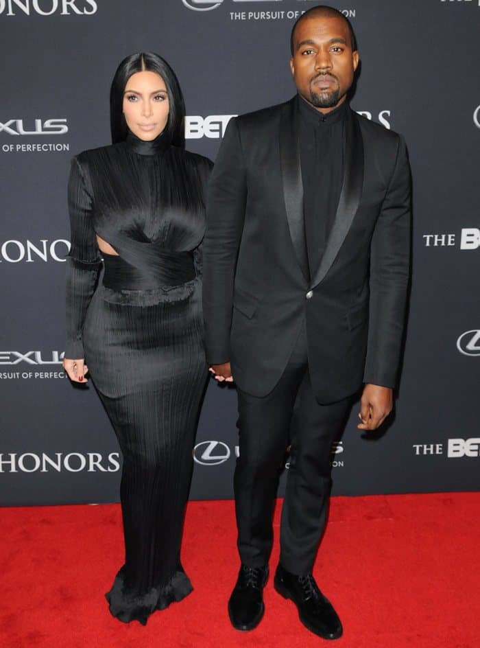 Kim Kardashian and Kanye West showcase coordinated black Balmain outfits at the 2015 BET Honors at the Warner Theatre in Washington on January 24, 2015 — while Kanye’s polished black shoes are on full display, Kim’s footwear remains hidden beneath the floor-sweeping hem of her sleek gown