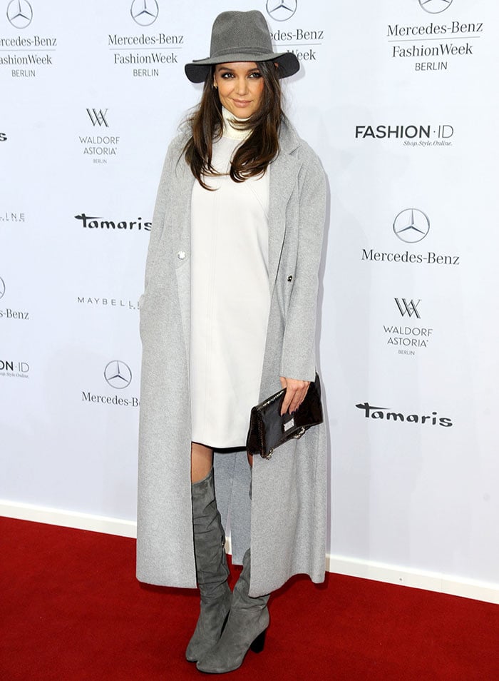 Katie Holmes rocked a high-neck dress, a gray duster coat, a wide-brimmed hat, and slouch boots