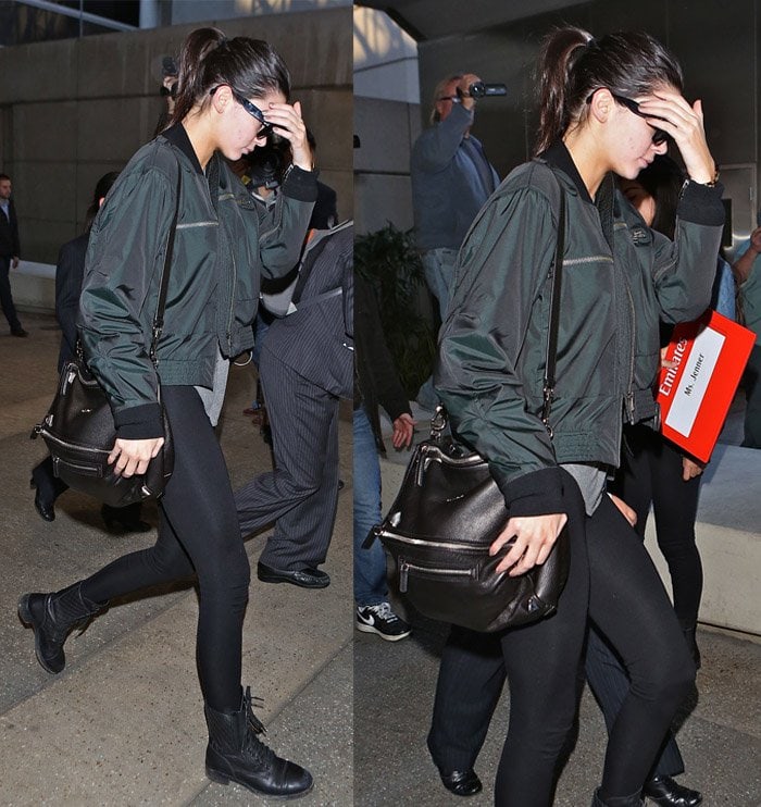 Kendall Jenner wears a green H&M bomber jacket and tights