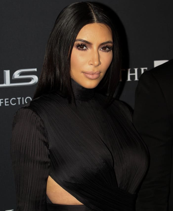 Kim Kardashian sported a toned down floor-length crepe gown from Balmain that for once did not show off her infamous cleavage