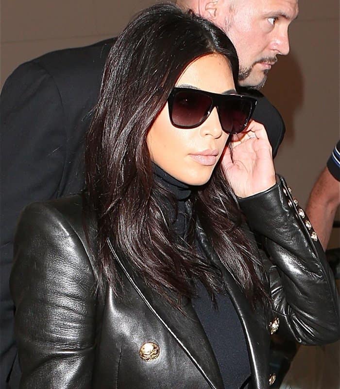 Kim Kardashian exudes sophistication at LAX, dressed in a sleek black Balmain blazer and oversized sunglasses