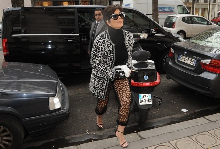 Kris Jenner shopping at the Yves Saint Laurent store in Paris wearing see-through mesh pants and carrying a Chanel clutch bag on January 27, 2015