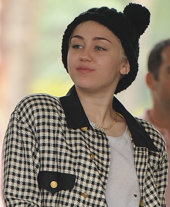 Miley Cyrus's white houndstooth vintage jacket and cat ears beanie