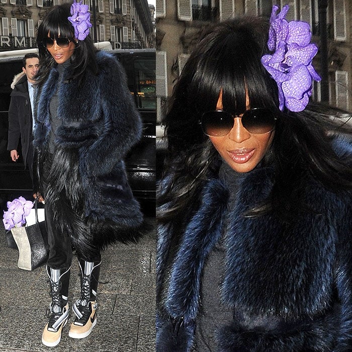 Naomi Campbell with a purple flower in her hair