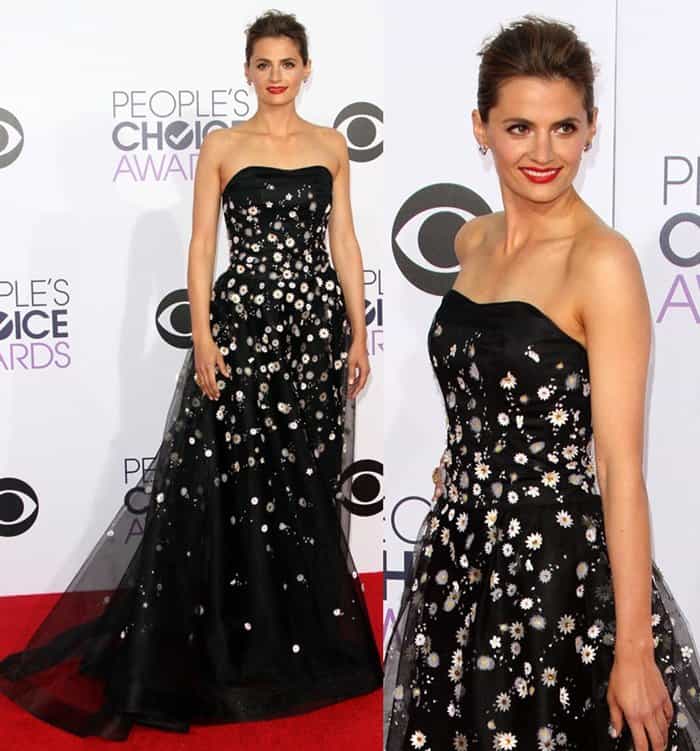 Stana Katic stuns in a black Carolina Herrera gown adorned with delicate daisy appliqués at the 2015 People's Choice Awards