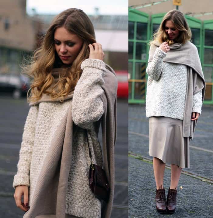 Aniri keeps neutral in a midi skirt and layers a scarf over her sweater