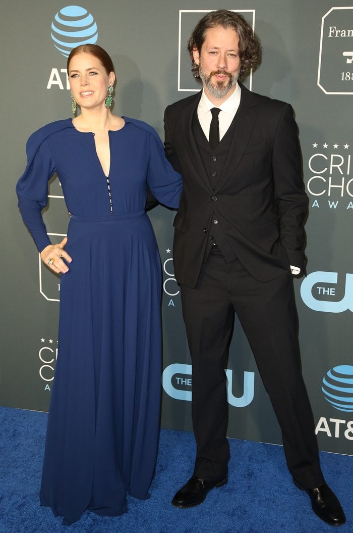Amy Adams stuns in a sleek blue Zac Posen gown and Jimmy Choo heels, accompanied by husband Darren Le Gallo in a classic three-piece suit at the 2019 Critics’ Choice Awards at the Barker Hangar in Santa Monica, California, on January 13, 2019