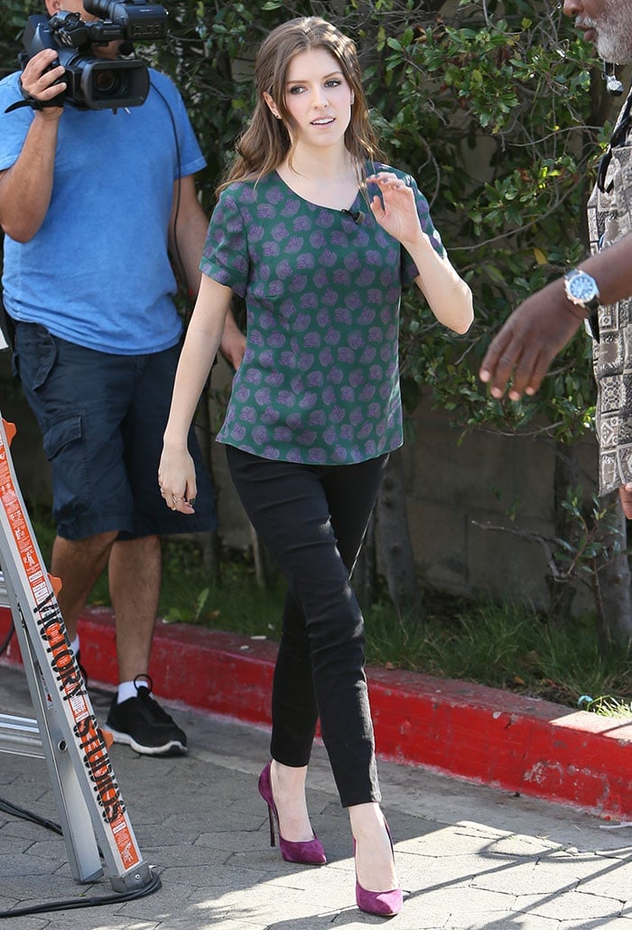 Anna Kendrick paraded her legs in a green-and-purple printed tee with fitted black pants