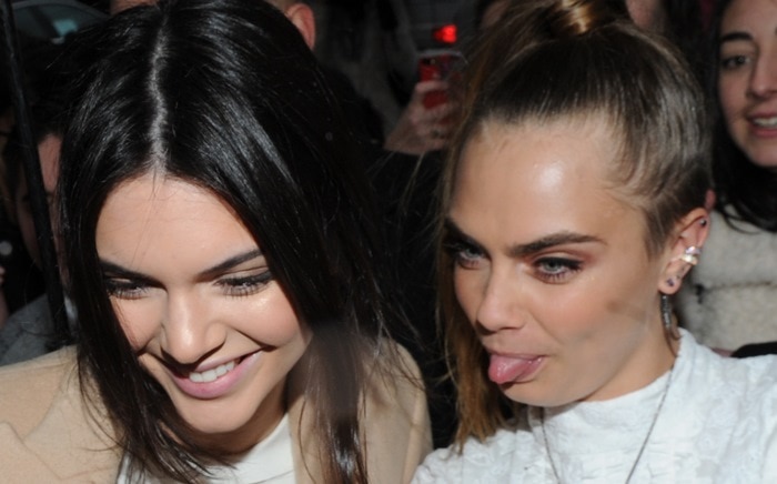 Kendall Jenner seemed to be having a great time with Cara Delevingne while sitting front row at the Topshop Unique show during London Fashion Week