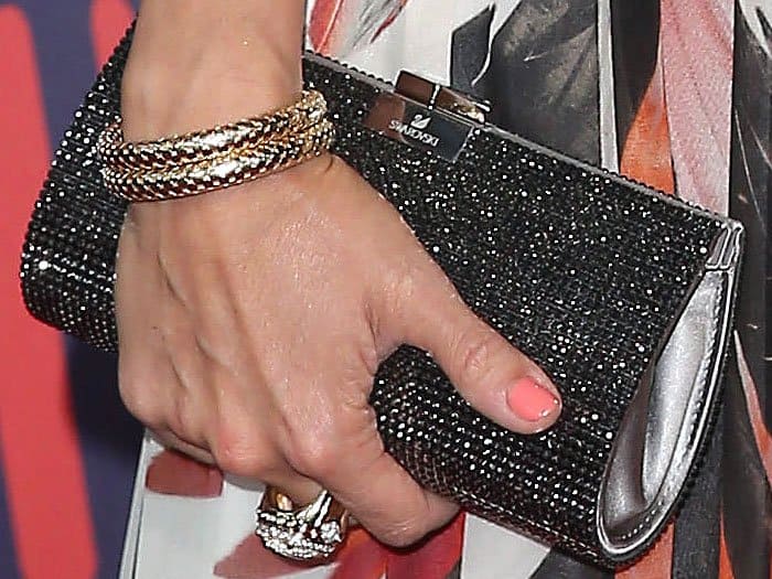 Closeup of Carrie Underwood's John Hardy bracelet, cuff ring, and Swarovski "New Power" crystal clutch