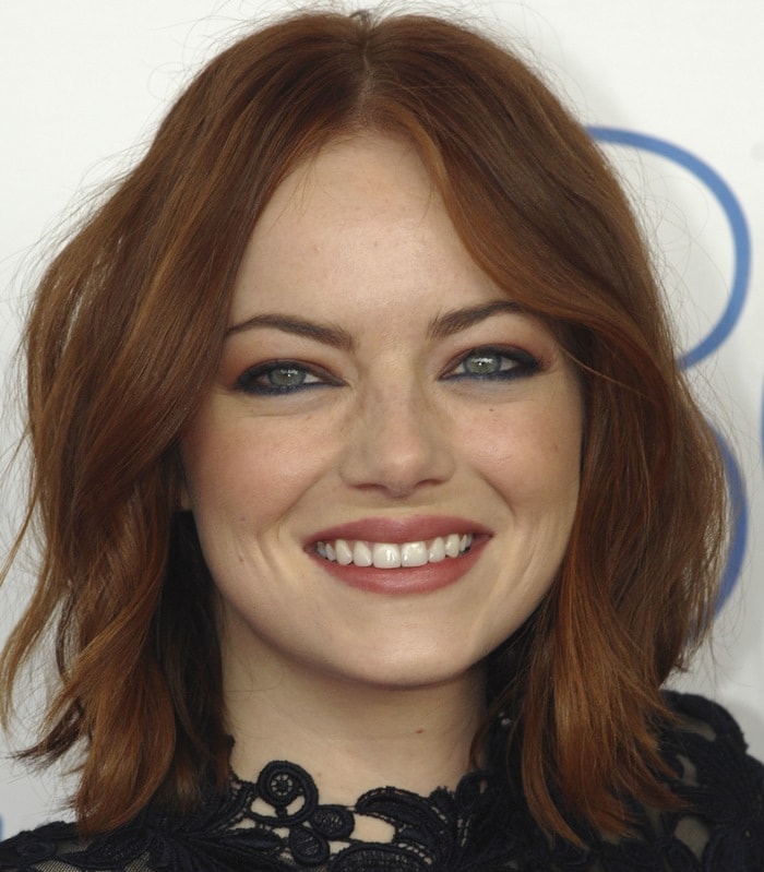 Emma Stone at the 2015 Film Independent Spirit Awards with soft waves and a natural makeup look featuring smokey eyes and nude lips