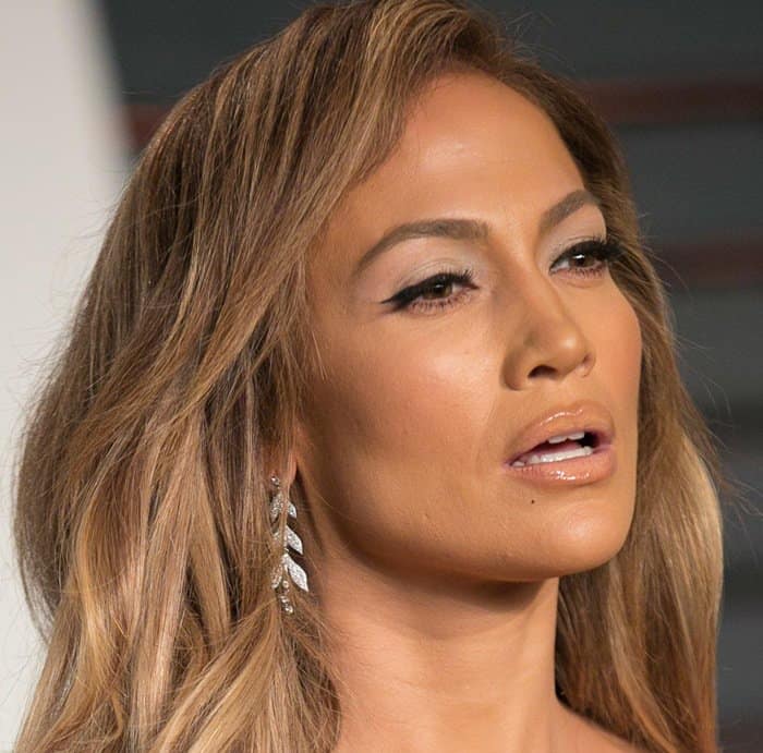 Jennifer Lopez appears to be caught mid-sentence, with her mouth slightly open and a look of surprise or curiosity on her face