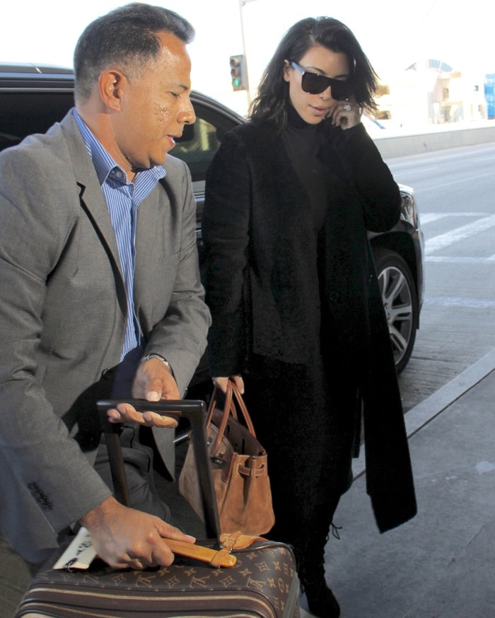 Kim Kardashian's tan monogram canvas Louis Vuitton Monogram Pegase 55 suitcase