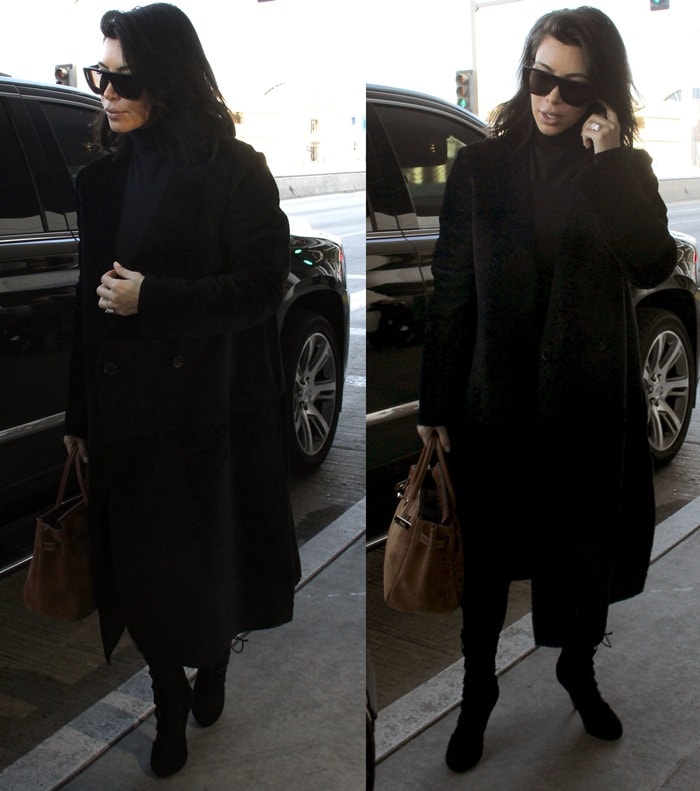 Kim Kardashian wears a long black coat at LAX