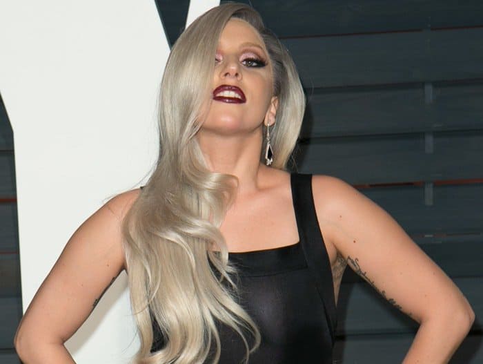 Lady Gaga strikes a pose in a daring sheer Azzedine Alaïa dress at the 2015 Vanity Fair Oscar Party