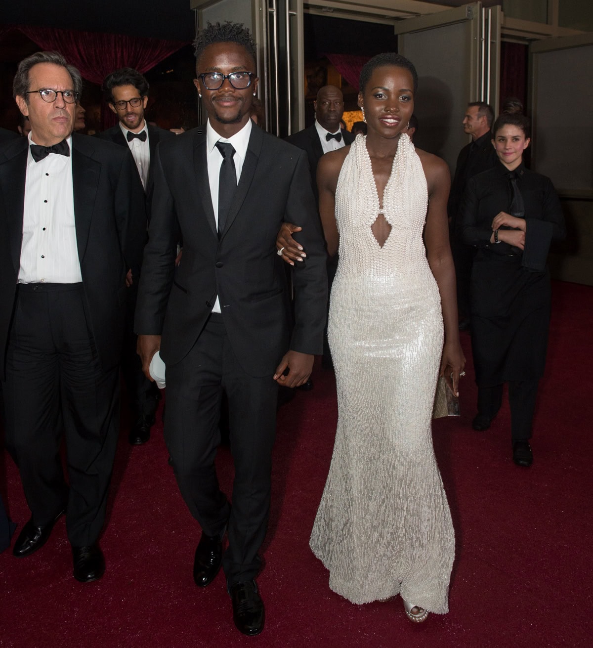 Lupita Nyong’o attends the Governor’s Ball after the 87th Oscars in her custom Calvin Klein gown and Nicholas Kirkwood pearl-platform slingback heels—perfectly echoing the 6,000 pearls on her dress