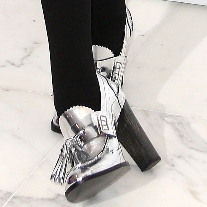 Silver tassel loafer pumps on rapper M.I.A.