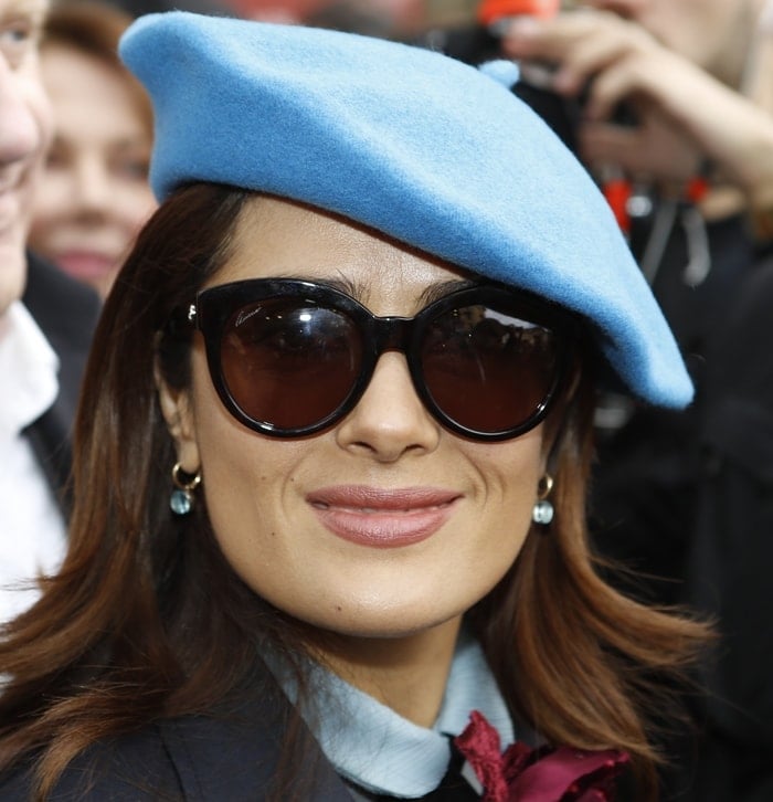 Salma Hayek wears a bright blue beret at the Gucci fashion show