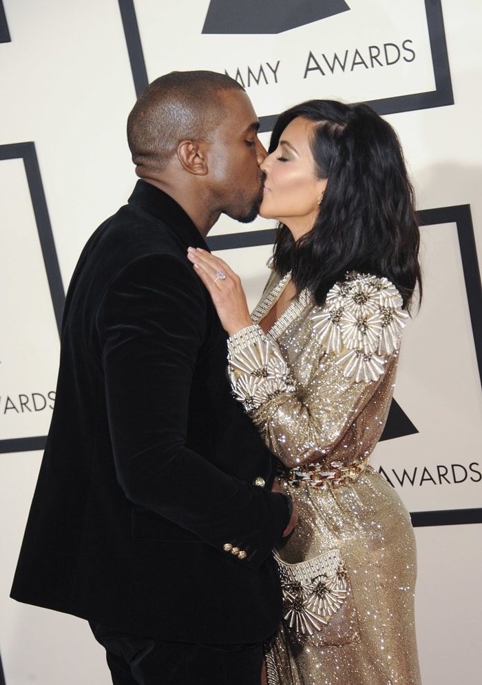 Kanye West and Kim Kardashian kiss on the red carpet of the Grammys