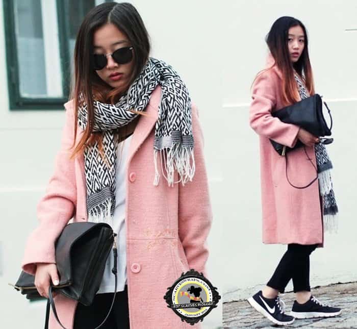 Trang rocks a geometric black-and-white scarf with a pink coat