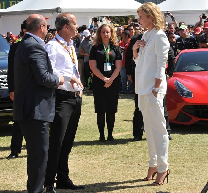 Charlize Theron rocked a white outfit consisting of a blazer, tailored pants, and a white shirt