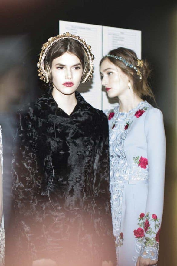 Dolce & Gabbana models showcase Swarovski crystal and pearl-embellished headphones with fur accents during the Fall 2015 show in Milan