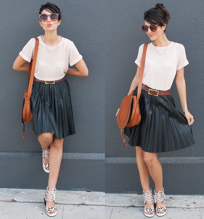 Laura paraded her legs in a belted pleated skirt and a plain top