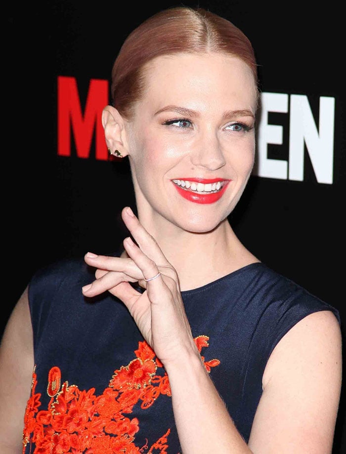 January Jones showcased a sleek center-parted bun paired with vibrant red lipstick, subtle eye makeup, and minimal jewelry