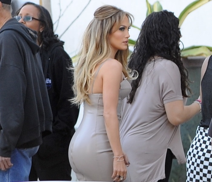 Jennifer Lopez showcases her curves in a fitted taupe dress while preparing for an "American Idol" taping