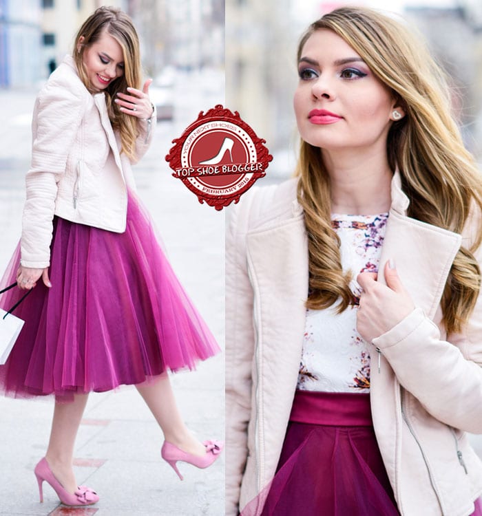 Julie wearing a printed top, a pretty burgundy tulle midi skirt, and a blush pink jacket
