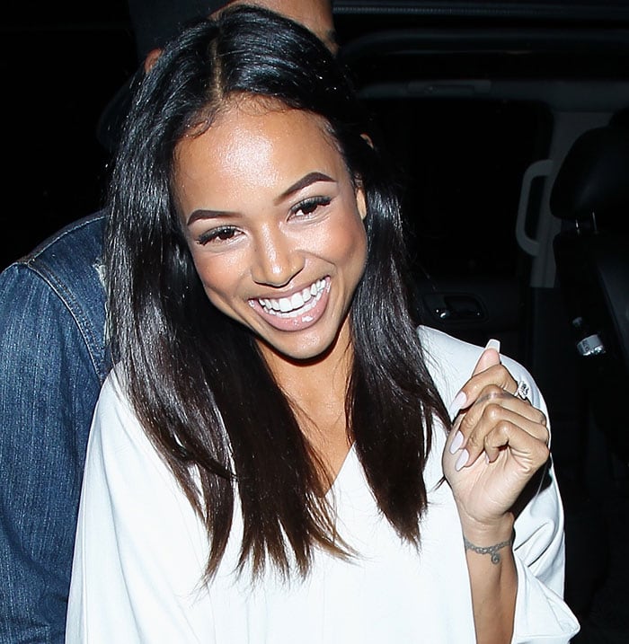 Karrueche Tran laughing as she made her way to the cocktail bar at Warwick nightclub