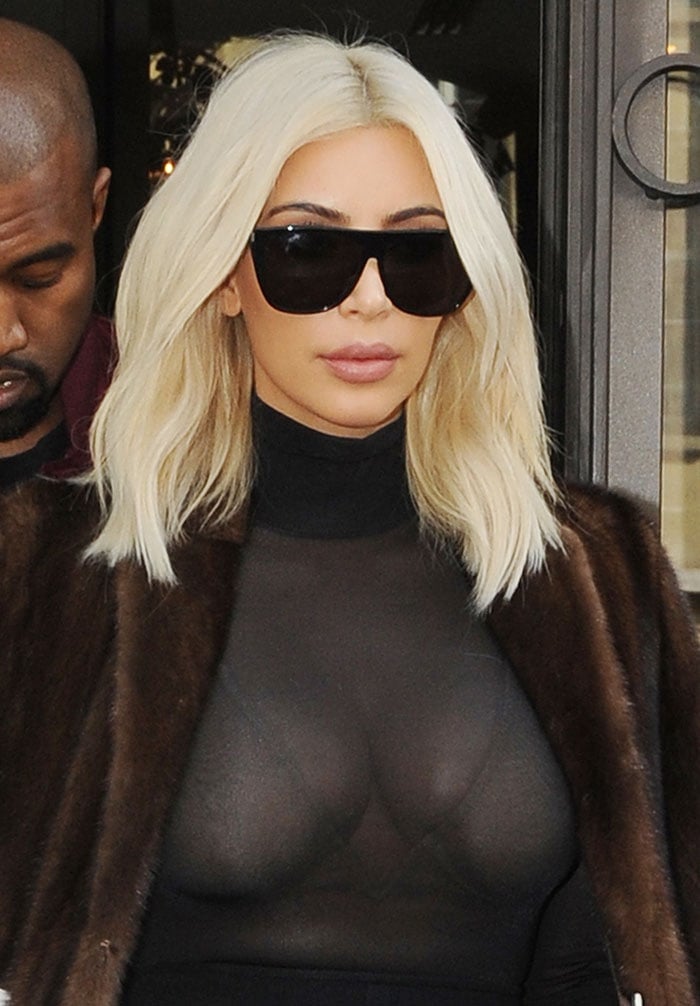 Kim Kardashian wears her blonde hair down as she leaves her hotel in Paris