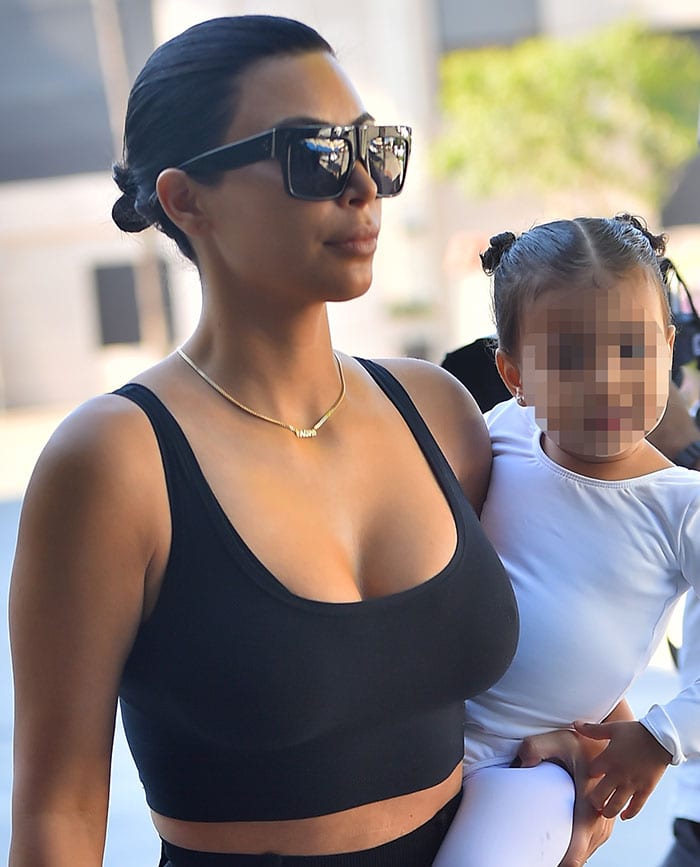 Kim Kardashian's newly dyed raven tresses in a slicked-back bun