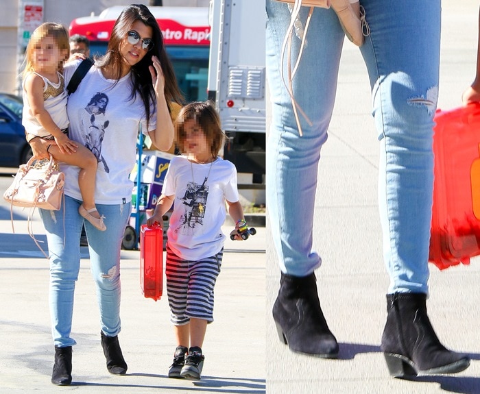Kourtney Kardashian wears a black-and-white printed shirt with light-wash destroyed jeans