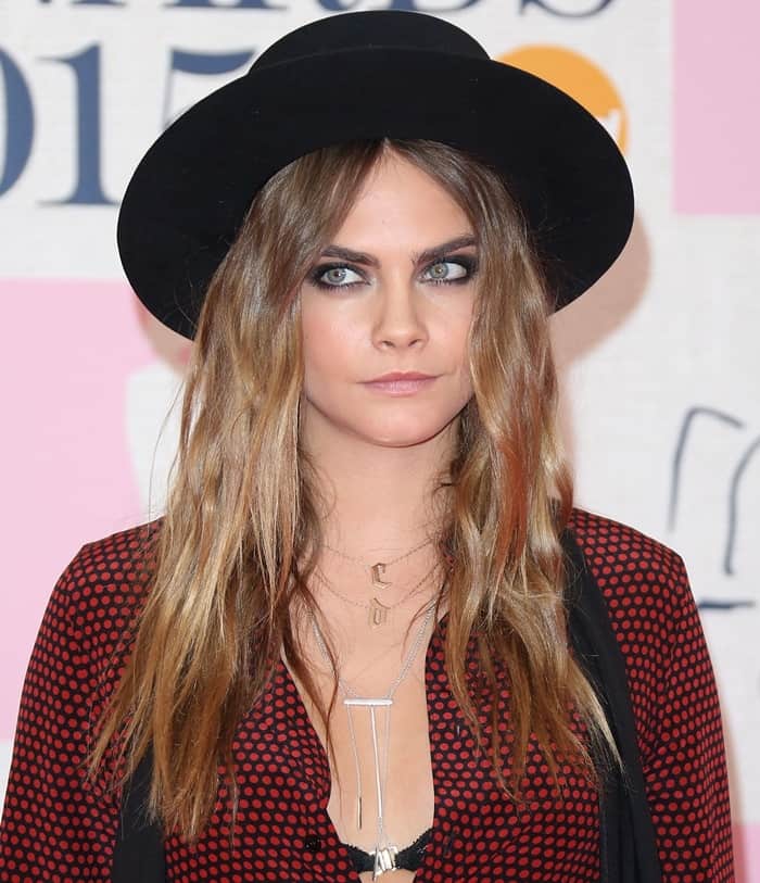 Cara Delevingne shows off her thin-strand jewelry and C & D initial necklace